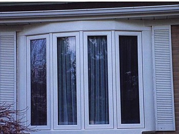 White bay windows with curtains instsalled by window and door company in FORHOMES Ltd.
