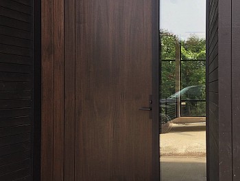 Pivot 8 foot door with vertical shadow grooves and clear sidelite and transom
