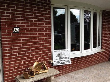 Custom white aluminum bow window installation on red brick home in Mississauga.