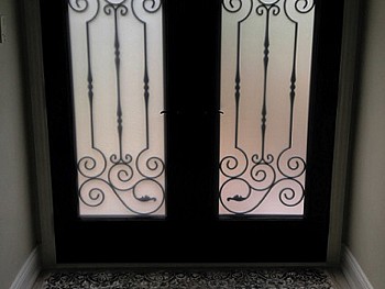 Almost Black two panel fiberglass entry door with custom wrought iron 3/4 glass