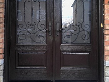 Double fiberglass door with dark chocolate stain and privacy glass/ wrought iron inserts