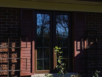 Contemporary windows with false shutters and grilles