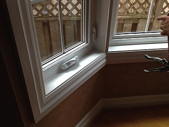 White tilt & turn window European style in custom bay window installation.